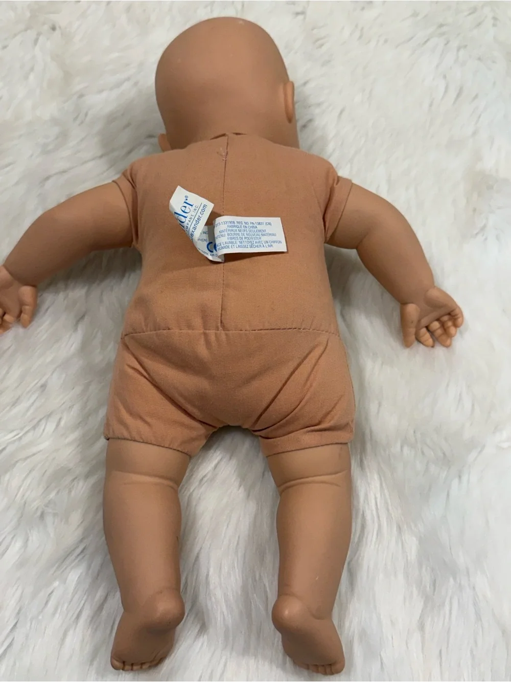 Madame Alexander 2010 Peach Vinyl Head Baby Doll with Blue Eyes